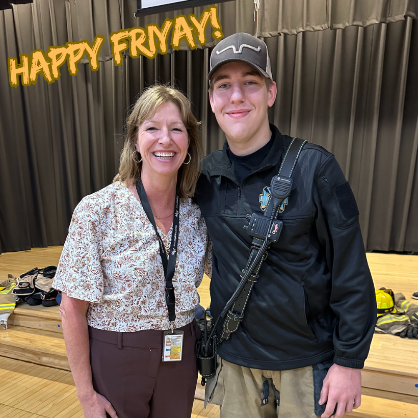 a woman with brown pants standing with a firefighter with a black shirt