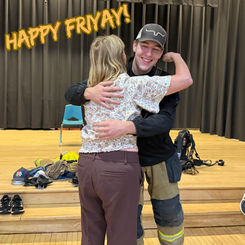a woman with brown pants hugging a firefighter with a black and yellow uniform 