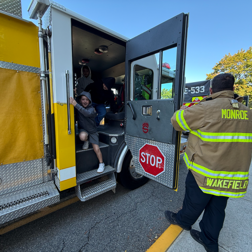 student getting off fire truck