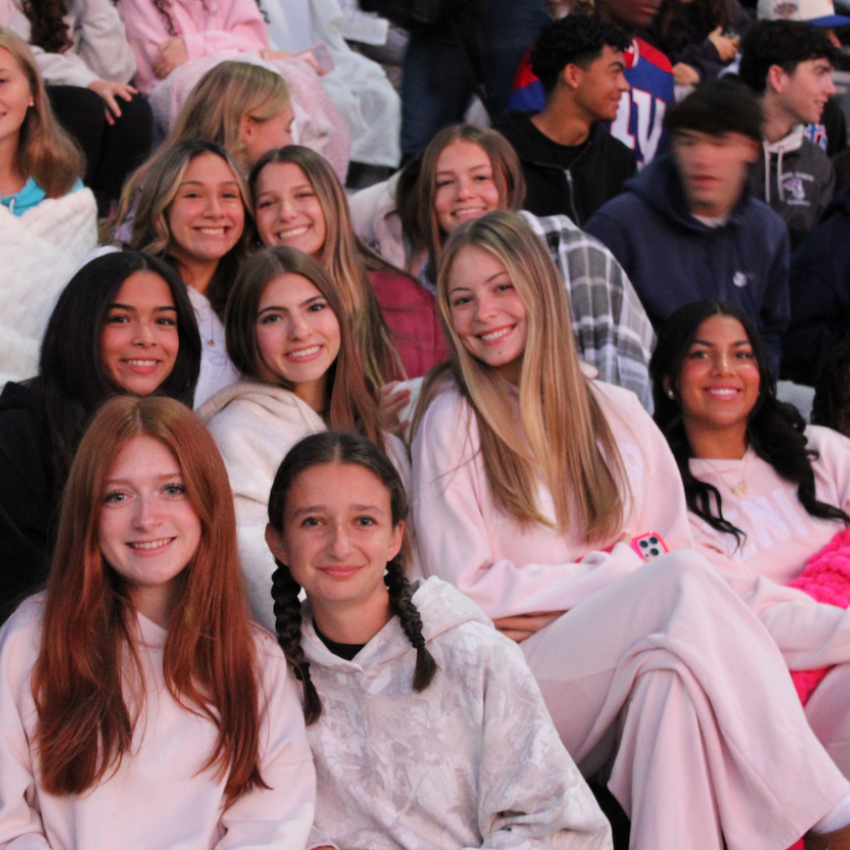 students sitting in the bleachers