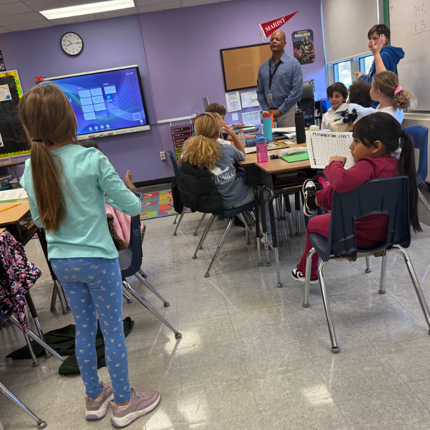 student standing talking to man in a blue shirt 