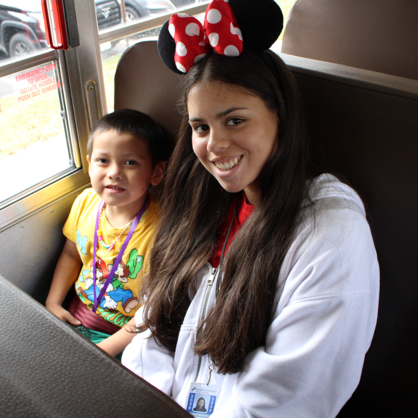 two student sitting on a bus 