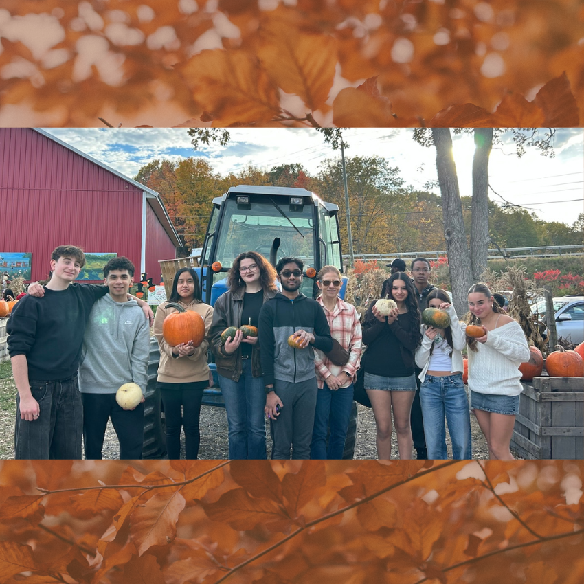 students holding pumpkins 