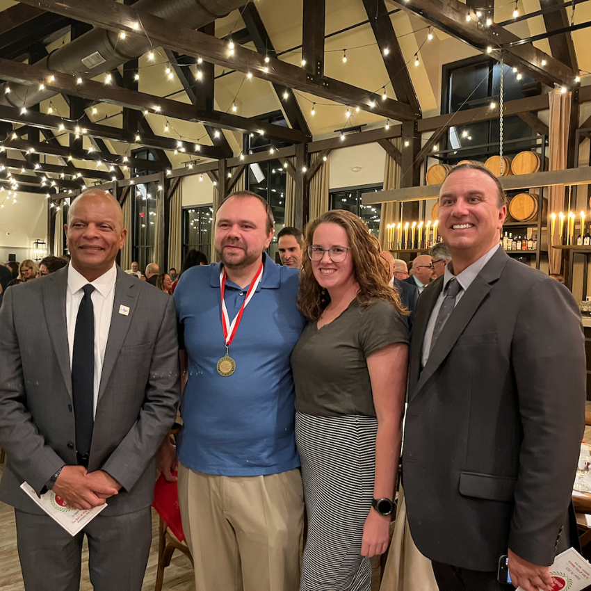 four people standing together