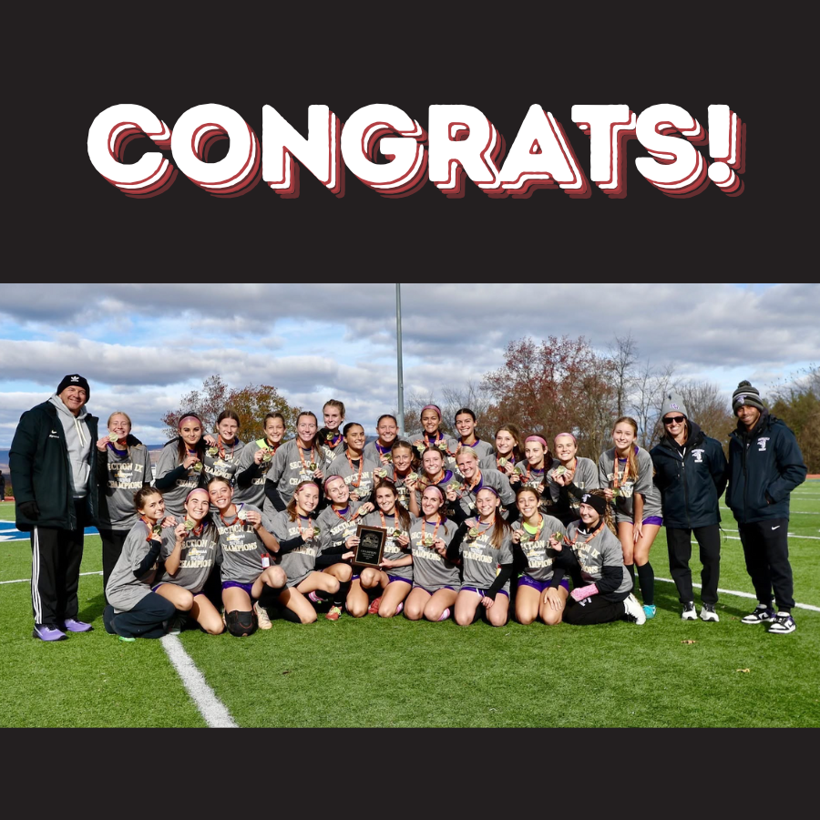soccer team posing with medals