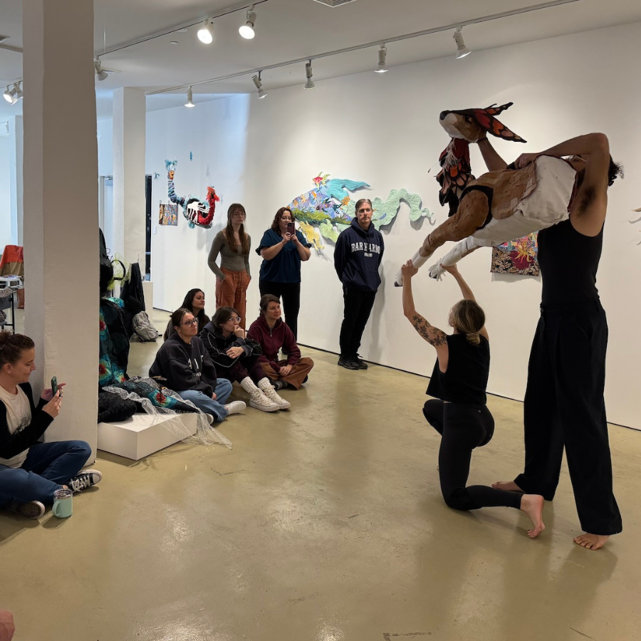 photo of two people holding a deer and others watching