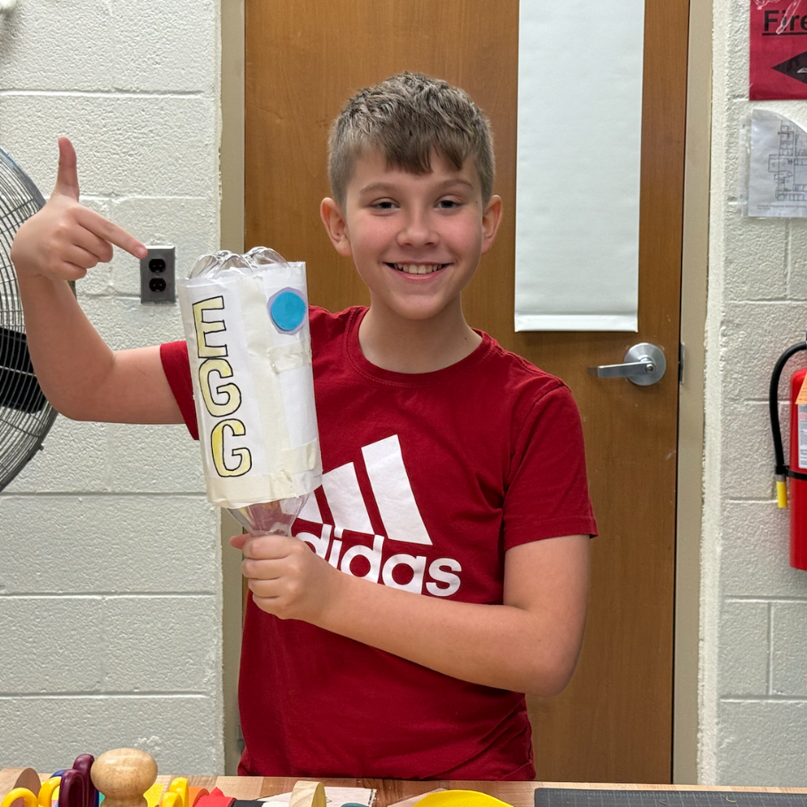 student holding bottle rocket 