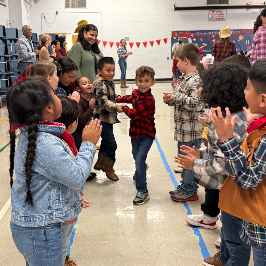 students dancing around a gym