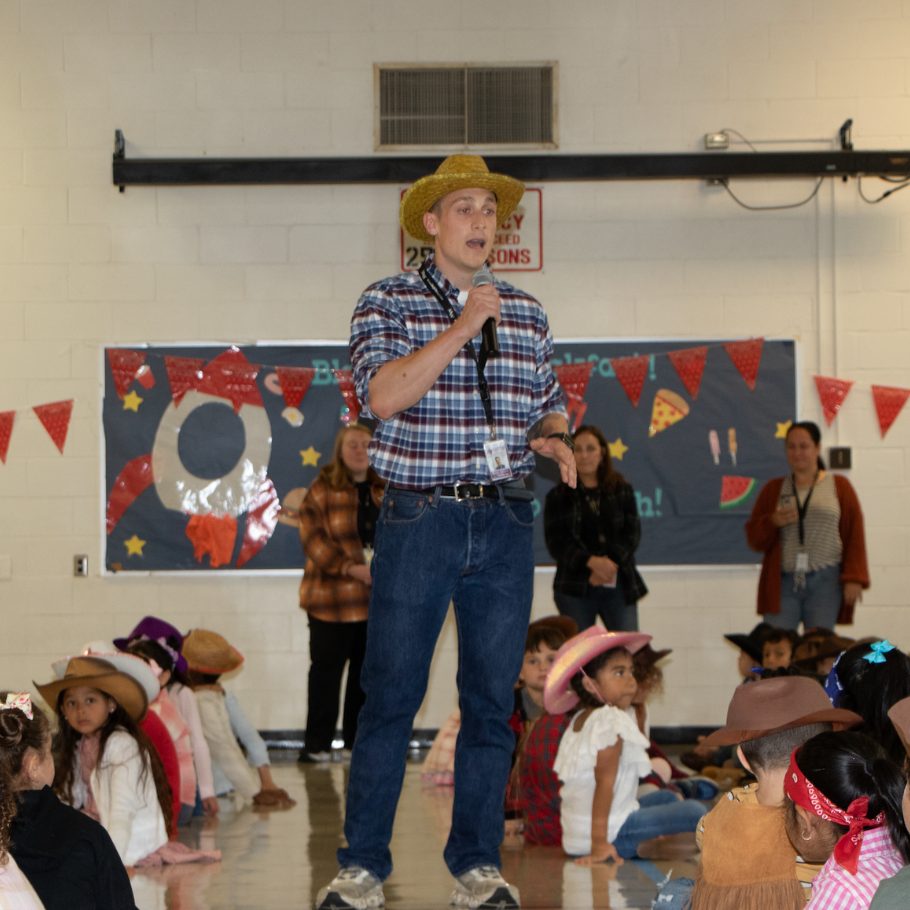 Man with a brown hat and plaid shirt 