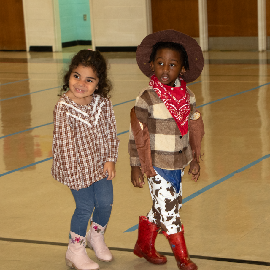 two students with red and pink cowboy boots and a brown hat