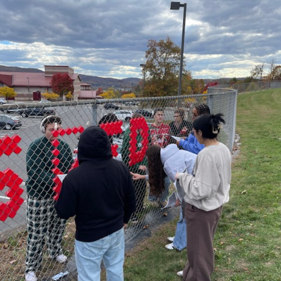 students decorating a fence red