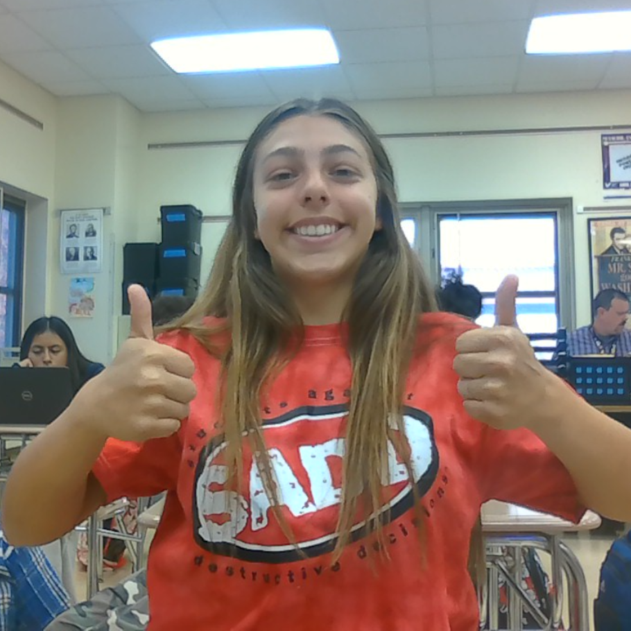 student wearing a red shirt giving thumbs up