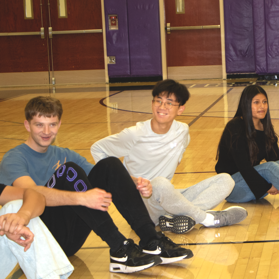 students sitting on the floor in gym 
