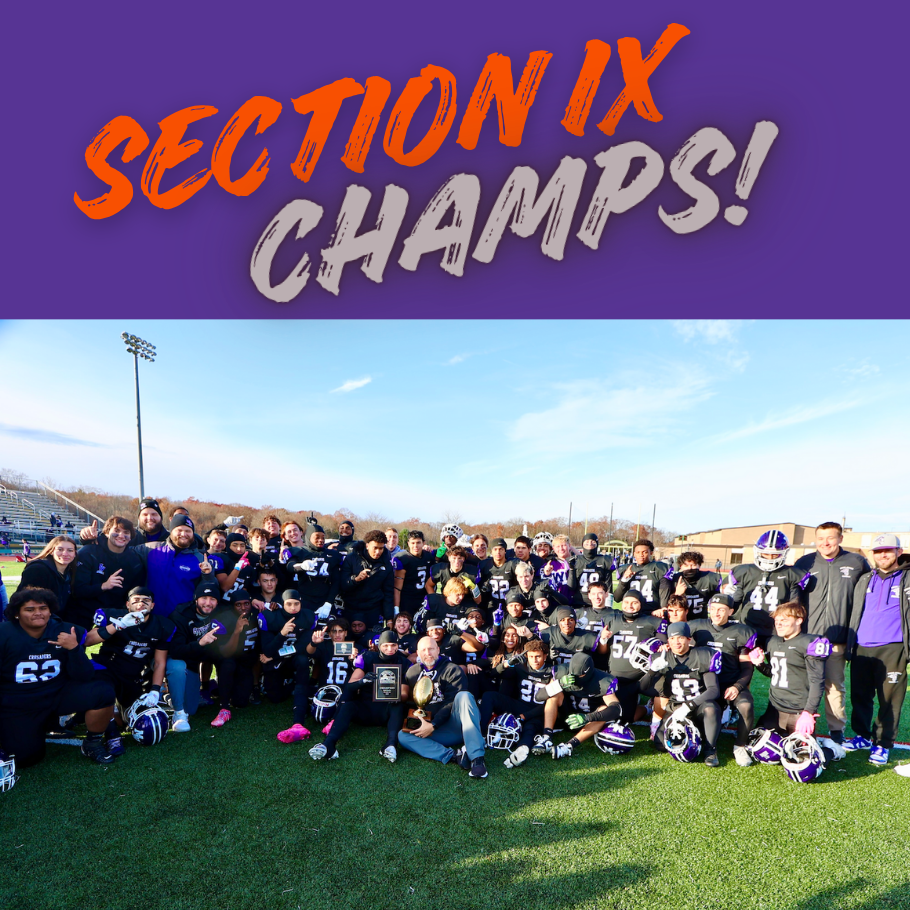 football team wearing purple and black standing in grass