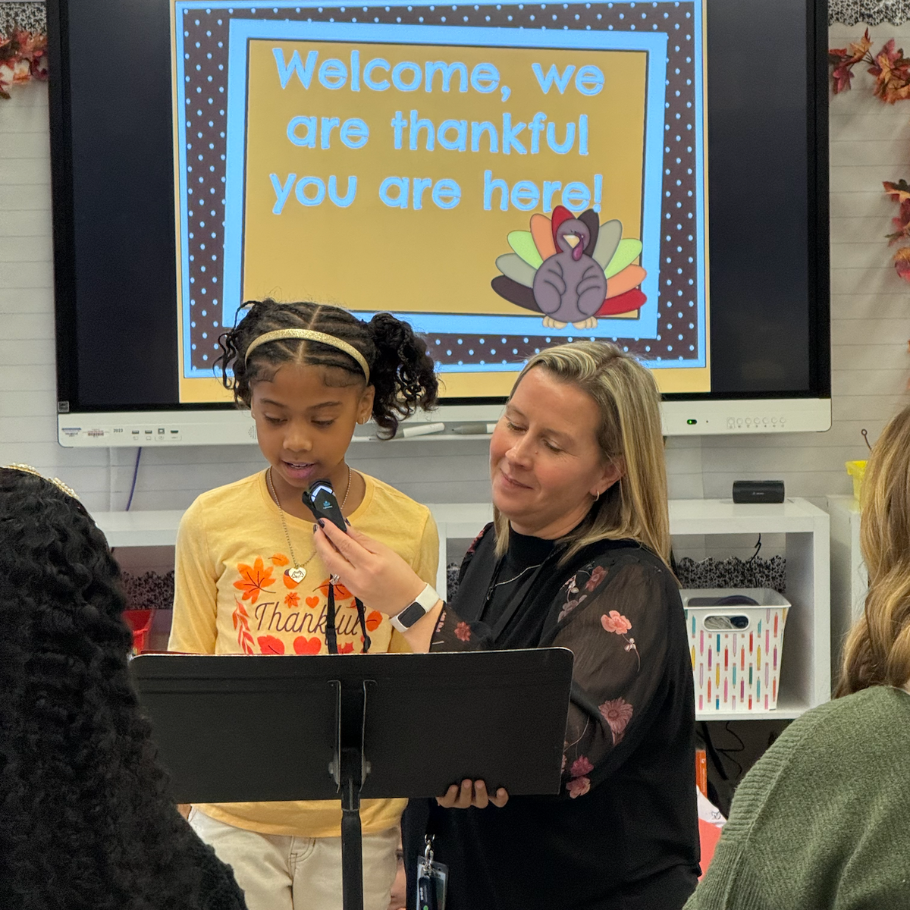 woman and student holding microphone