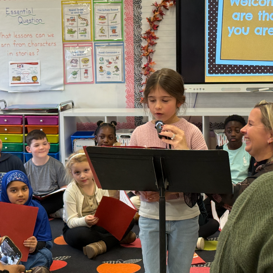 student reading in front of a black podium