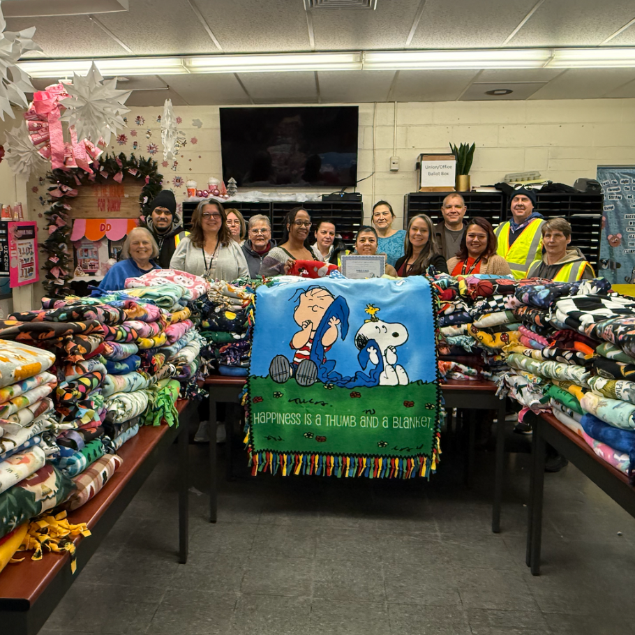 people standing around a blanket donation 