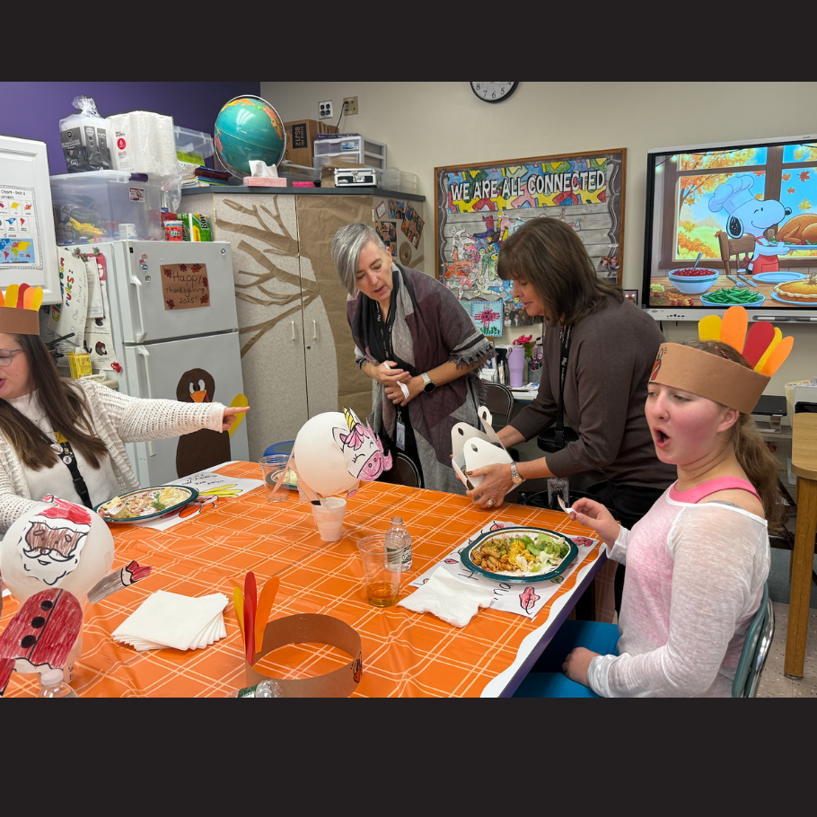 girl with feather hat at an orange table 