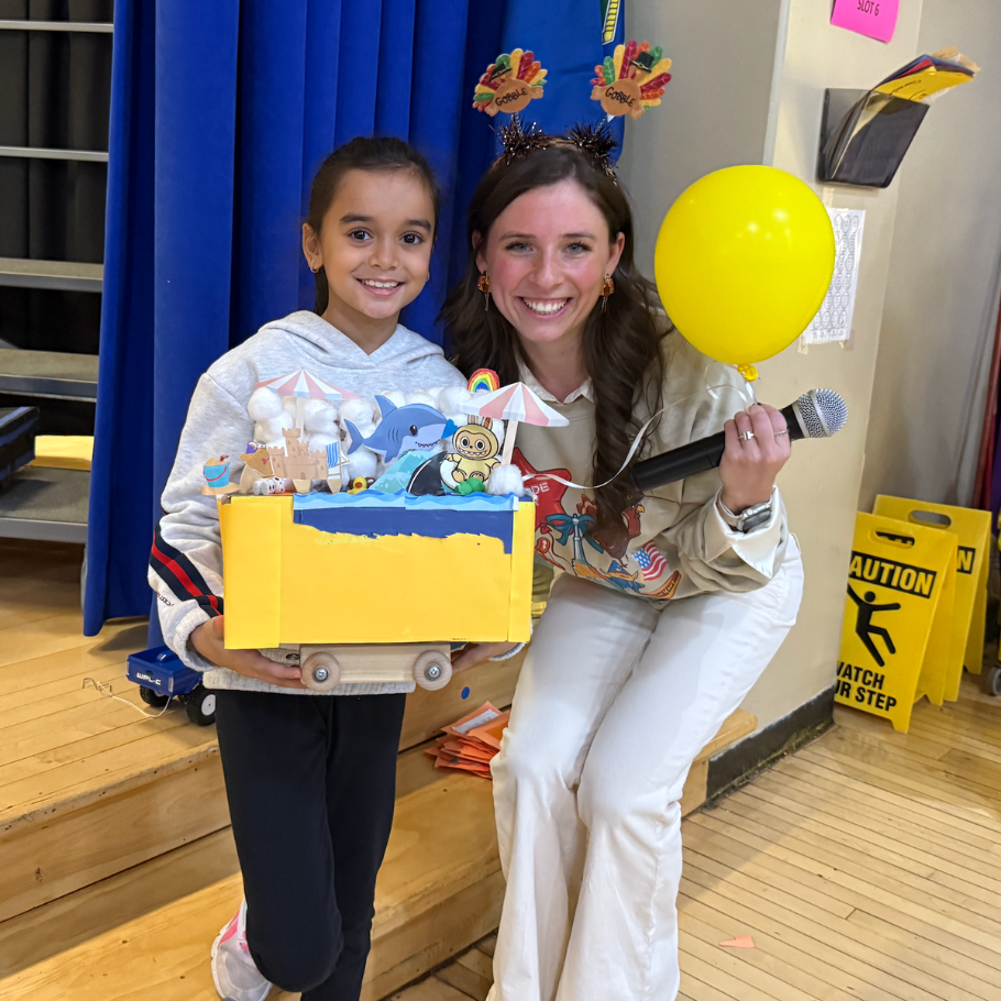 woman and student holding yellow balloon