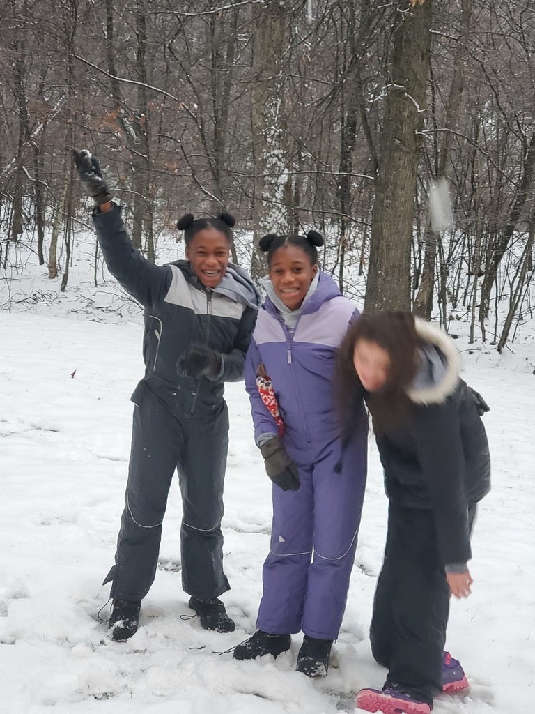 three girls having fun in the snow