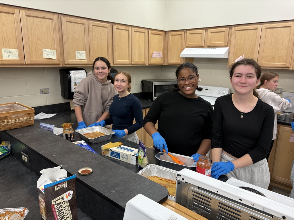 students making lasagna for senior citizens 