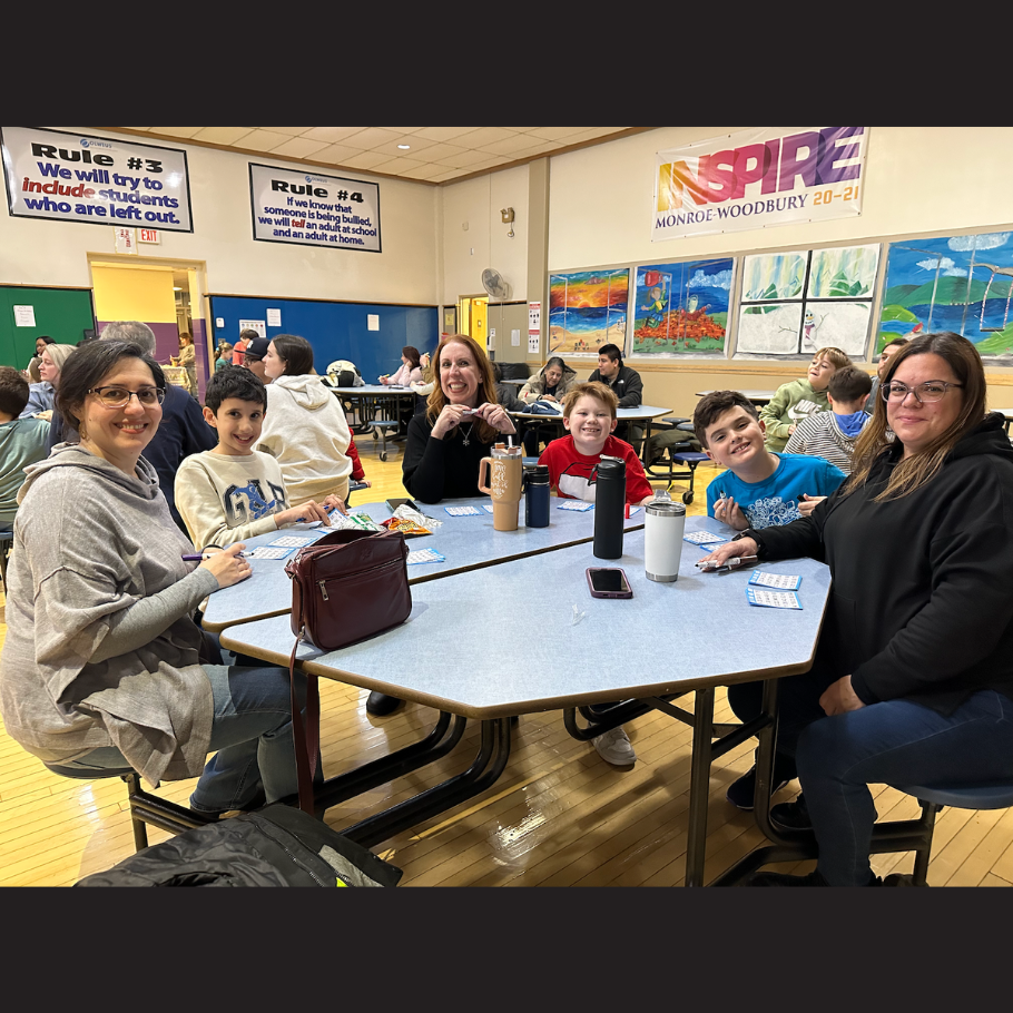 family sitting around a blue table 