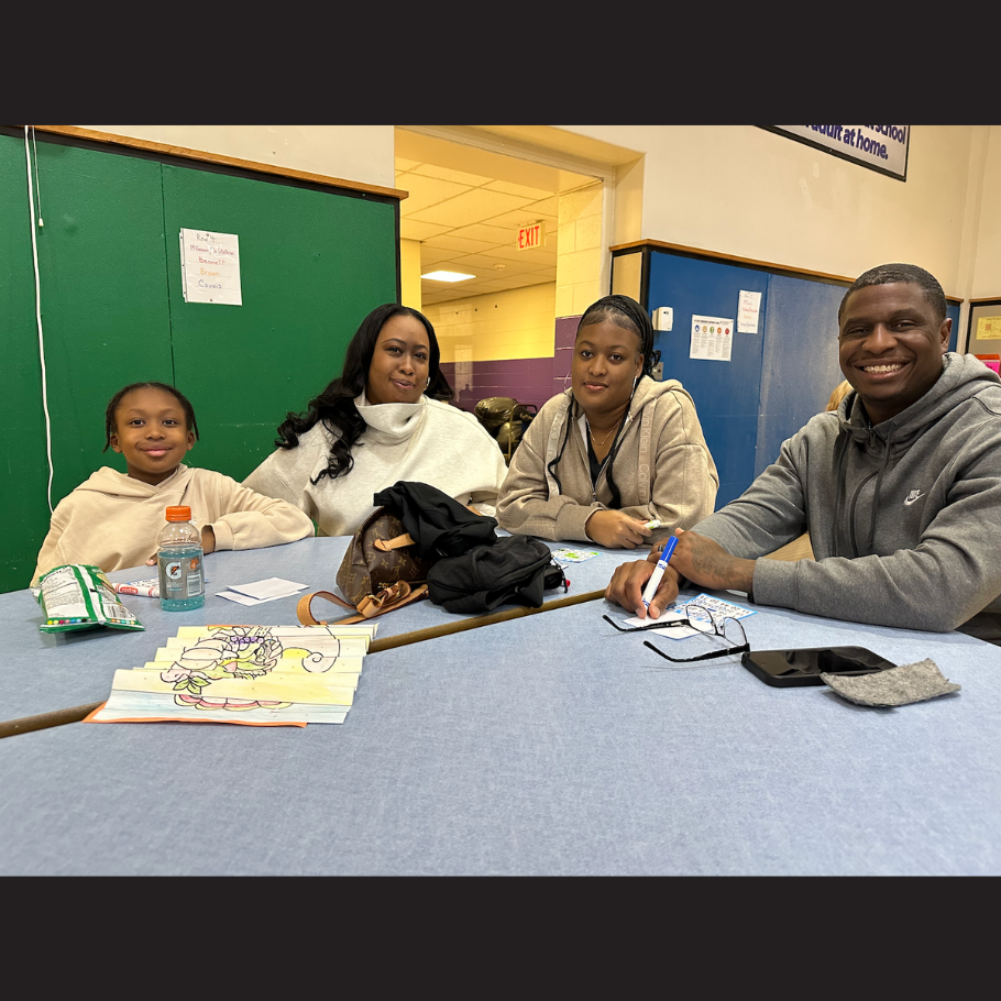 family of four sitting at a blue table 