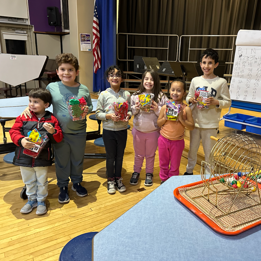 students holding candy prizes