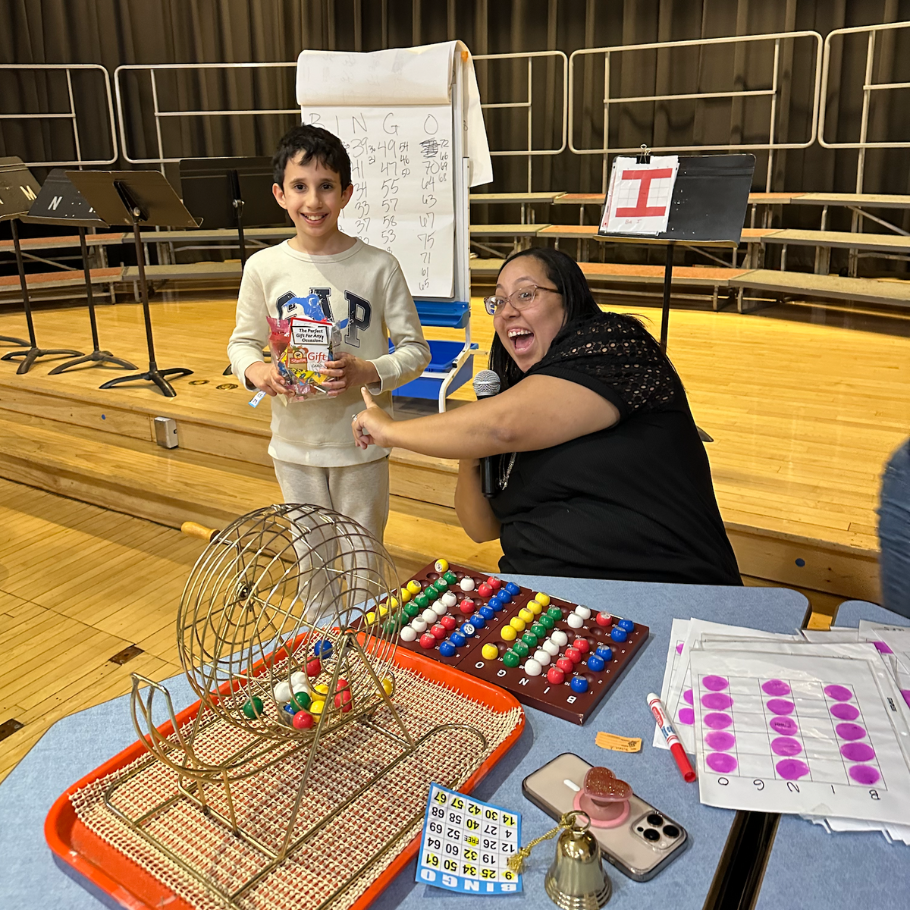 student holding candy prize next to colorful bingo balls