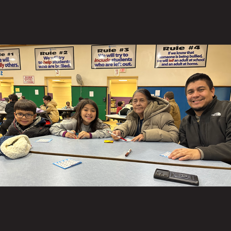 family sitting at a table with pens