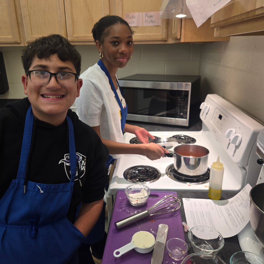 students standing in front of stoves