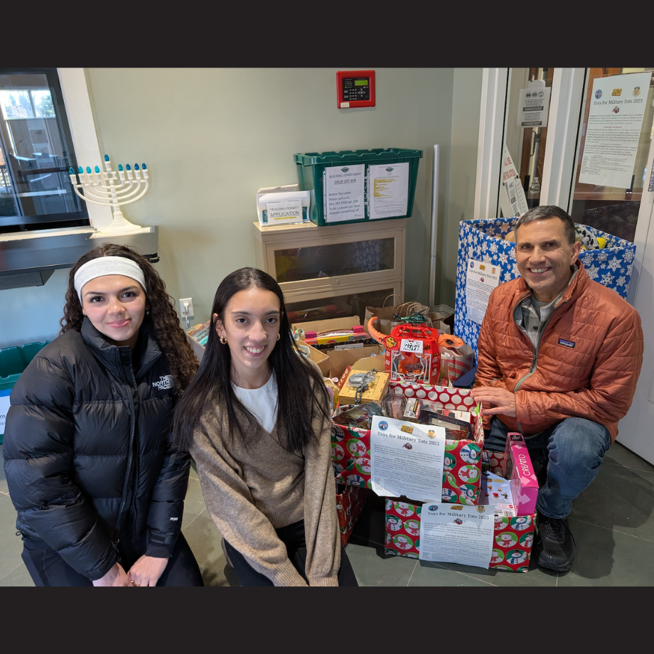three people kneeling in front of presents