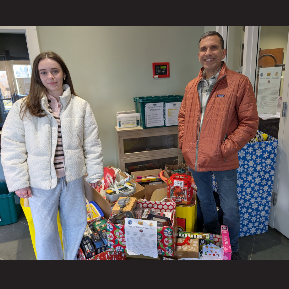two people standing in front of presents