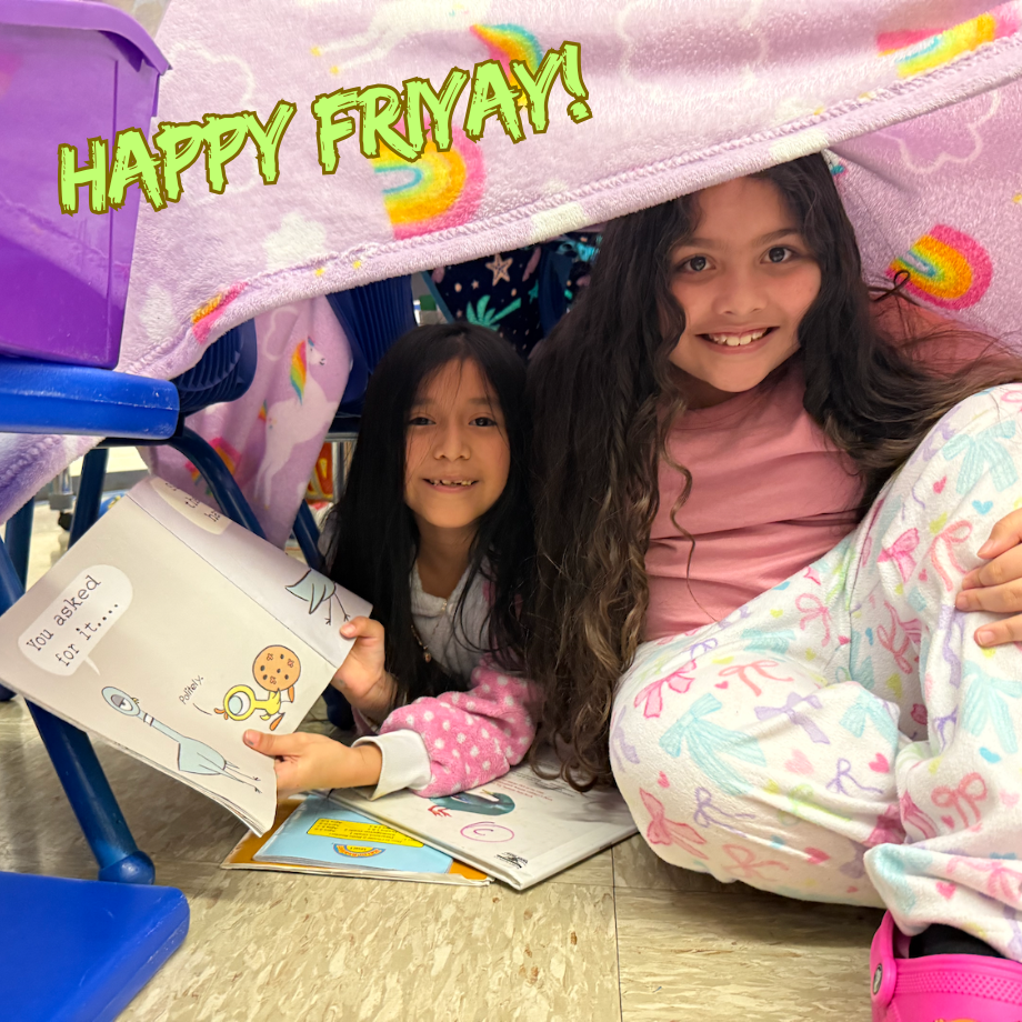 two students sitting under a pink blanket holding a book