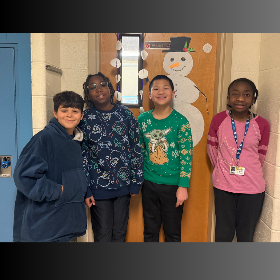 four students wearing green, blue and pink sweaters