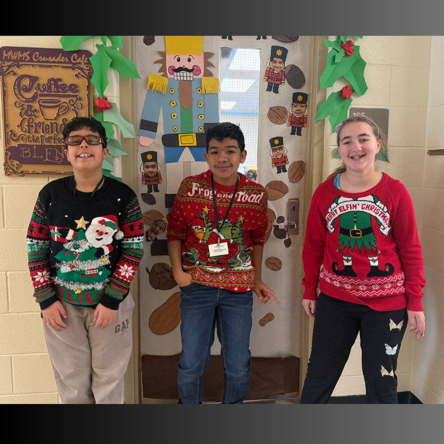 three students wearing red and green sweaters 