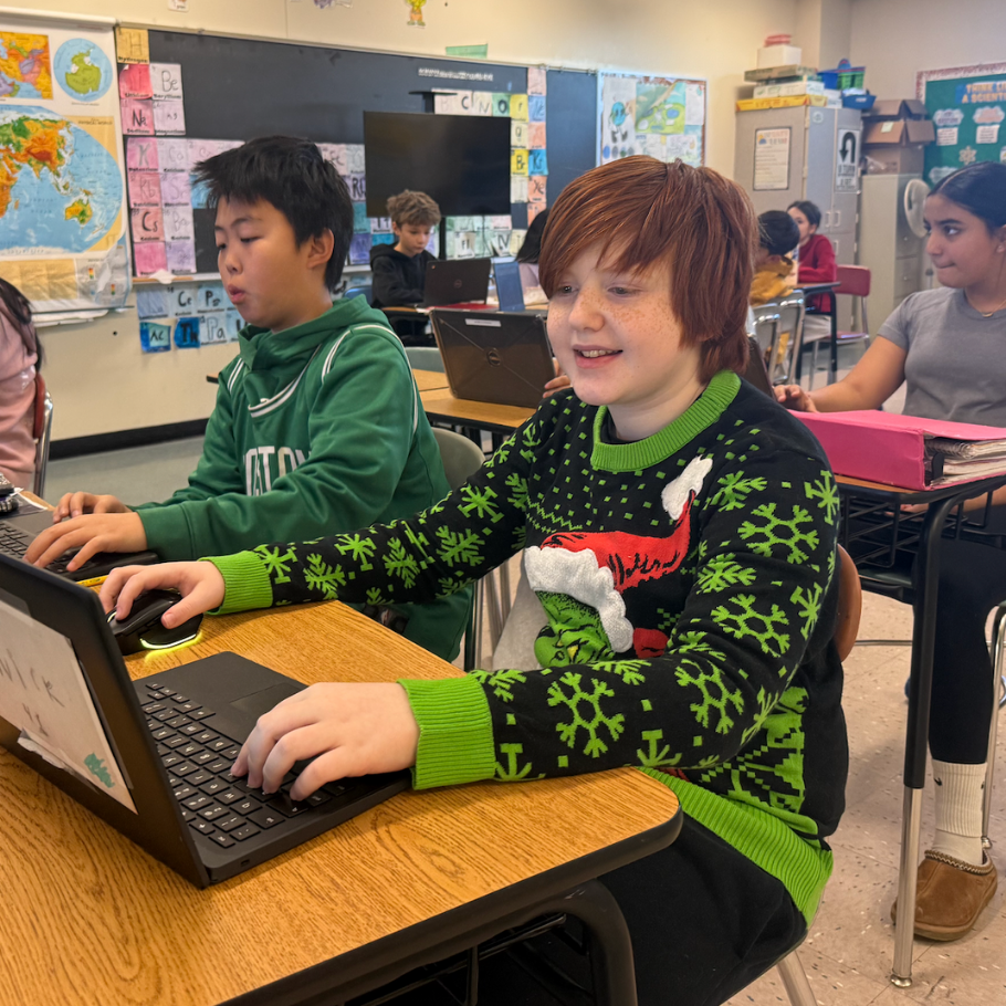 boy wearing grinch green sweater 