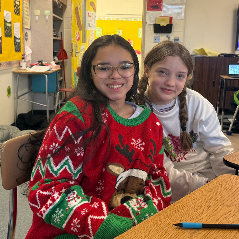 two girls wearing red and white sweaters 