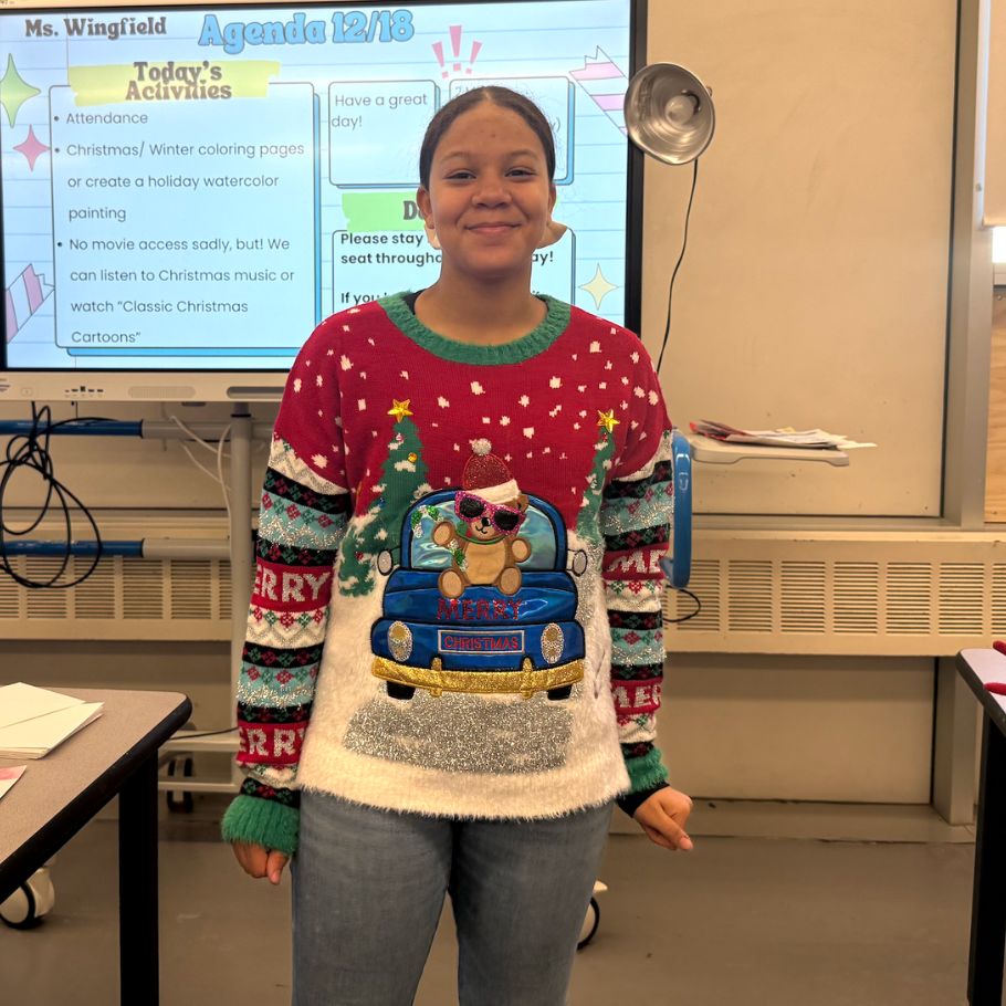 girl wearing sweater with a bear driving a car