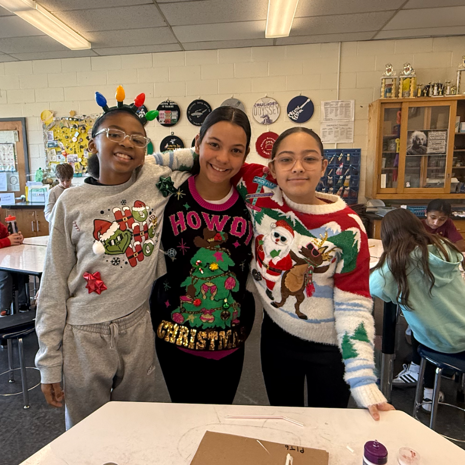 three students wearing colorful sweaters