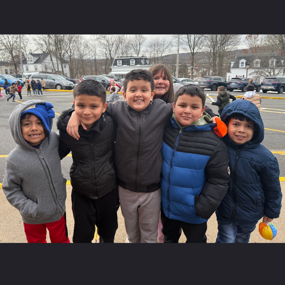 five students with coats standing outside 