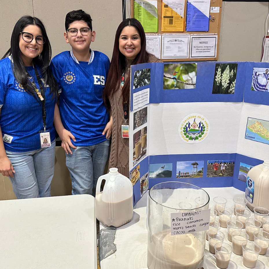 three people with blue shirts standing 