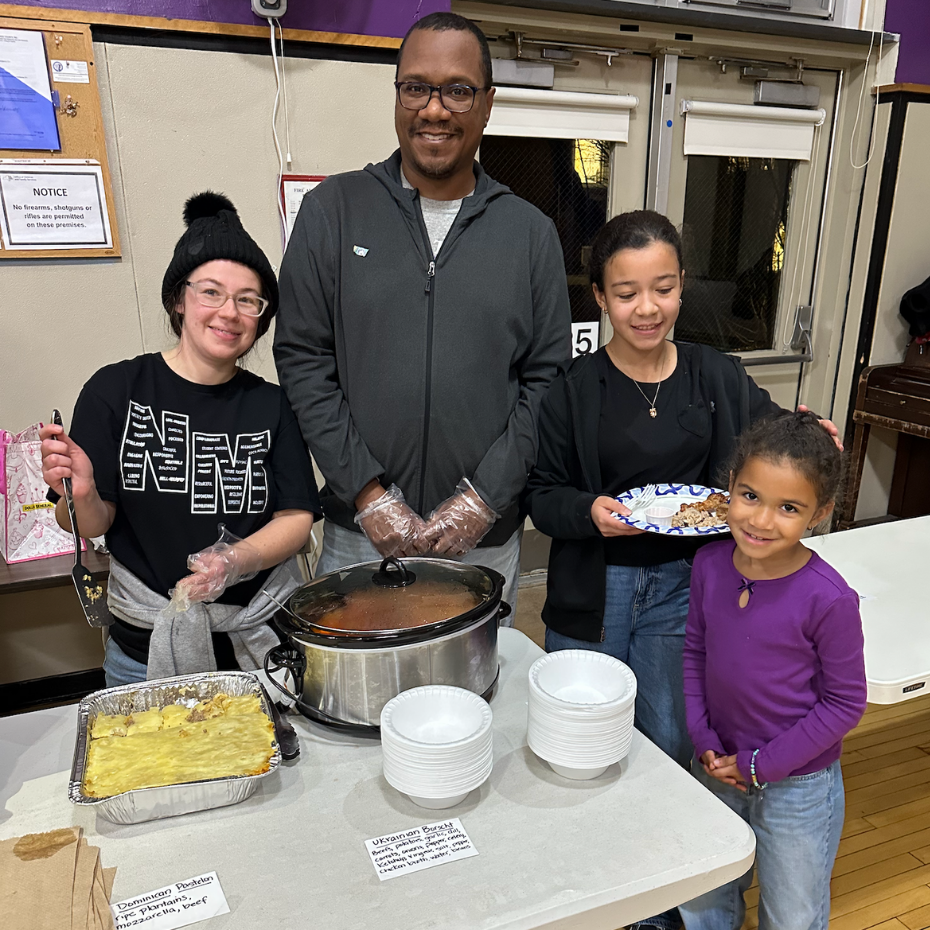 four people holding plates