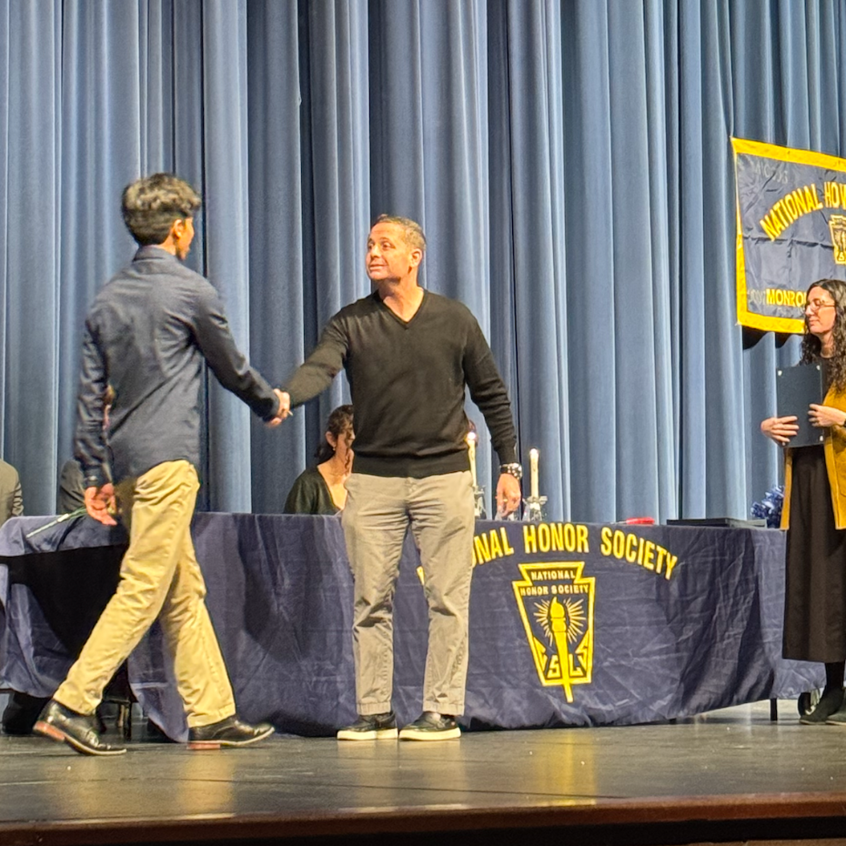 man shaking another man's hand 