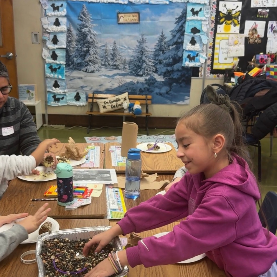 student with hand in bird seed