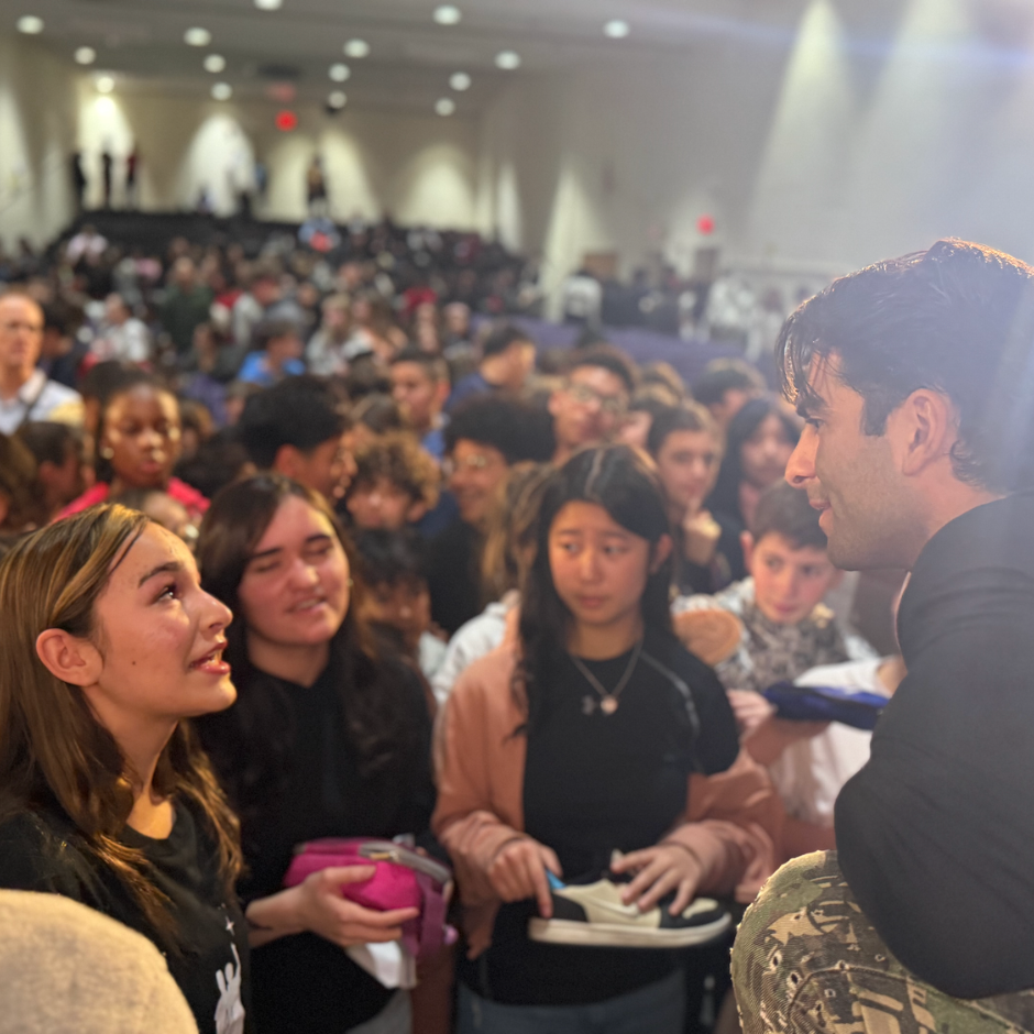 students and man looking at each other 