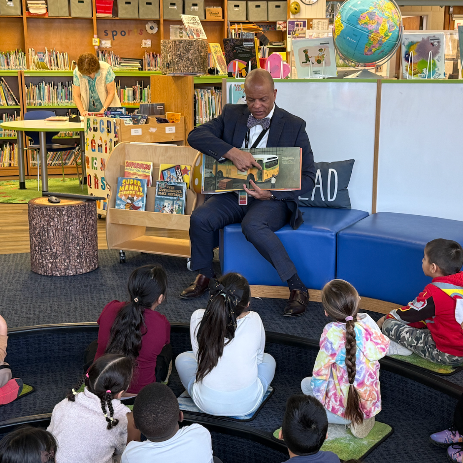 man holding a book in a library 
