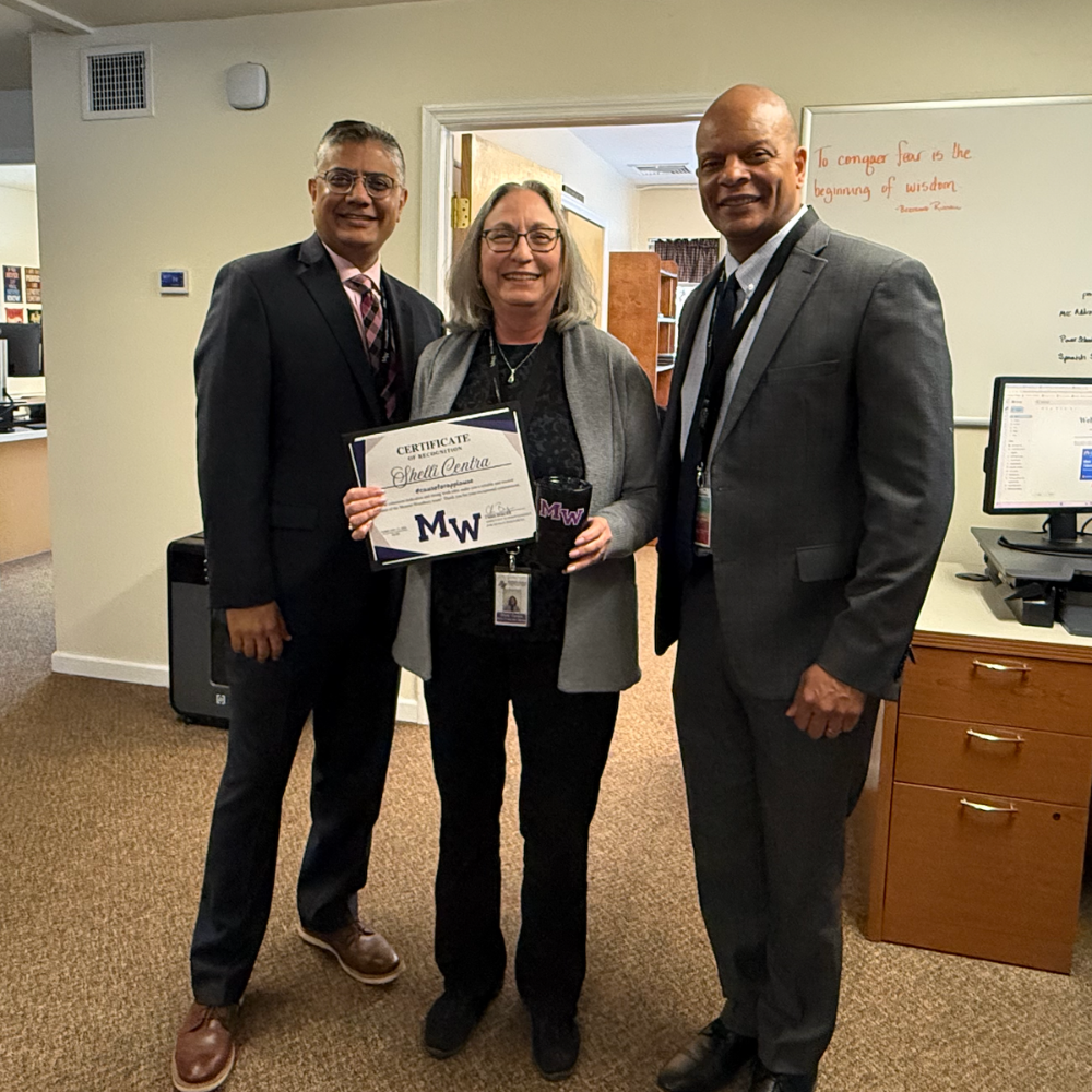 three people standing in office 