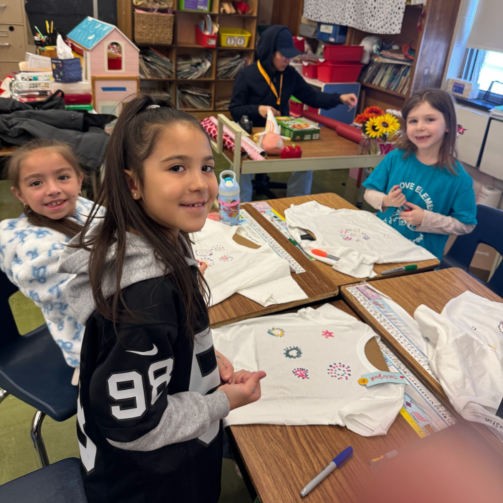 three students sitting at a table 