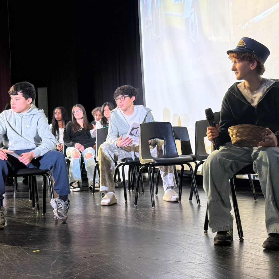 students sitting on stage